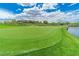Community golf course featuring beautiful ponds, lush greens, and beautiful houses at 17 Chatmoss Rd, Henderson, NV 89052