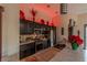 Modern kitchen with stainless steel appliances, dark cabinets, and a tile countertop under recessed lighting at 17 Chatmoss Rd, Henderson, NV 89052