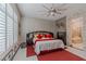 Serene primary bedroom features a brick accent wall, neutral tones, and a well-lit en-suite bathroom at 17 Chatmoss Rd, Henderson, NV 89052