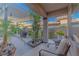 Cozy patio with plants, comfortable seating, and a charming pergola for outdoor relaxation and enjoyment at 17 Chatmoss Rd, Henderson, NV 89052