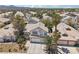 Desirable neighborhood featuring a well-maintained two-story home with mature trees and desert landscaping at 1707 Navarre Ln, Henderson, NV 89014