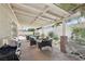 A covered back patio with backyard views of seating, a pool, and a lush landscape at 1707 Navarre Ln, Henderson, NV 89014