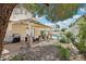 A covered back patio with backyard views of seating, a pool, and a lush landscape at 1707 Navarre Ln, Henderson, NV 89014