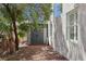 A fenced-in yard featuring gravel, an exterior storage shed, and the home's exterior at 1707 Navarre Ln, Henderson, NV 89014