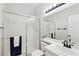 Bathroom featuring a shower, a white tiled sink, and towel racks at 1707 Navarre Ln, Henderson, NV 89014