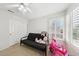 Bedroom space with a futon, window with shutters, ceiling fan, and closet space at 1707 Navarre Ln, Henderson, NV 89014
