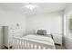 Neutral bedroom with a bed, ceiling fan, window with shutters, and a lovely chest of drawers at 1707 Navarre Ln, Henderson, NV 89014
