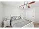Bright bedroom featuring a ceiling fan, neutral walls, carpeted floor, and a comfortable queen size bed at 1707 Navarre Ln, Henderson, NV 89014
