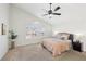 Bright bedroom with a ceiling fan and large window with shutters, allowing for plenty of natural light at 1707 Navarre Ln, Henderson, NV 89014