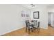 Cozy dining area with glass table, wood floors, shuttered window and minimalist decor at 1707 Navarre Ln, Henderson, NV 89014