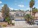 Attractive two-story residence boasting a well-maintained lawn, mature trees, and a spacious three-car garage at 1707 Navarre Ln, Henderson, NV 89014