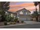 Charming two-story home with a three-car garage, desert landscaping, and beautiful desert sunset at 1707 Navarre Ln, Henderson, NV 89014