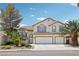 Attractive two-story home with a three-car garage, desert landscaping, and mature palm trees at 1707 Navarre Ln, Henderson, NV 89014