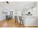 Open kitchen with stainless steel appliances, white countertops, adjacent to a cozy dining area and barstools at 1707 Navarre Ln, Henderson, NV 89014