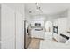 A bright, all-white kitchen with stainless steel appliances, tiled countertops, and plenty of cabinet space at 1707 Navarre Ln, Henderson, NV 89014