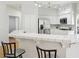 Open kitchen with stainless steel appliances, white tile countertops, seating area and barstools at 1707 Navarre Ln, Henderson, NV 89014