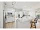 Bright kitchen featuring white cabinets, tiled countertops, stainless steel appliances, and breakfast bar seating at 1707 Navarre Ln, Henderson, NV 89014