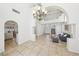 Spacious living room with high ceilings, tile floors, an elegant chandelier and staircase to the upper level at 1707 Navarre Ln, Henderson, NV 89014
