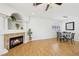Open-plan living space features a fireplace, dining area, wood floors, and shuttered window at 1707 Navarre Ln, Henderson, NV 89014
