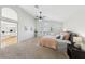 Spacious main bedroom with high ceilings, ceiling fan, carpet flooring, and adjoining ensuite bathroom at 1707 Navarre Ln, Henderson, NV 89014