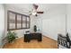 Bright office space featuring a ceiling fan, a large window with shutters, and closet for storage at 1707 Navarre Ln, Henderson, NV 89014