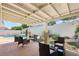 Relaxing covered patio with stylish outdoor seating, ideal for enjoying the serene backyard and pool area at 1707 Navarre Ln, Henderson, NV 89014