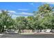 A welcoming community entrance sign surrounded by mature trees and beautiful landscaping at 1901 Calle De Espana, Las Vegas, NV 89102