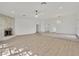 Spacious living room with hardwood floors, a stone fireplace, and a elegant chandelier at 1901 Calle De Espana, Las Vegas, NV 89102