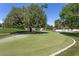 A perfectly manicured putting green for golf enthusiasts, complemented by mature trees at 1901 Calle De Espana, Las Vegas, NV 89102