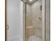 Modern shower featuring tiled walls, a built-in bench, and glass doors at 1901 Calle De Espana, Las Vegas, NV 89102