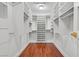 Spacious walk-in closet featuring custom shelving and hardwood floors at 1901 Calle De Espana, Las Vegas, NV 89102