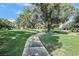 Picturesque walkway surrounded by mature landscaping and lush green grass, creating a serene outdoor experience at 1901 Calle De Espana, Las Vegas, NV 89102