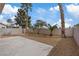 The backyard features a concrete patio, decorative rock landscaping, and mature trees at 1909 Falling Tree Ave, North Las Vegas, NV 89031