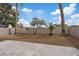 The backyard features a concrete patio, decorative rock landscaping, and mature trees at 1909 Falling Tree Ave, North Las Vegas, NV 89031