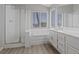 Bathroom with dual sinks, bath tub, shower and hardwood floors at 1909 Falling Tree Ave, North Las Vegas, NV 89031