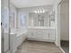 Bathroom with dual sinks, bath tub, shower and walk in closet at 1909 Falling Tree Ave, North Las Vegas, NV 89031