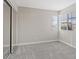 Bedroom with carpet, windows with blinds and mirrored closet at 1909 Falling Tree Ave, North Las Vegas, NV 89031