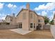A two-story home has a sliding glass door leading to a concrete patio in the backyard at 1909 Falling Tree Ave, North Las Vegas, NV 89031