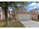 Inviting two-story house with a spacious two-car garage and manicured lawn, showcasing curb appeal at 1909 Falling Tree Ave, North Las Vegas, NV 89031