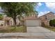 Charming two-story home featuring a two-car garage and a well-maintained front yard with mature landscaping at 1909 Falling Tree Ave, North Las Vegas, NV 89031