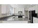 Contemporary kitchen boasting white cabinets, stainless steel appliances, and modern finishes at 1909 Falling Tree Ave, North Las Vegas, NV 89031