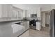 Stylish kitchen with white cabinets, stainless steel appliances, and sleek countertops, ideal for cooking at 1909 Falling Tree Ave, North Las Vegas, NV 89031