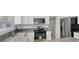 Updated kitchen with white cabinets, stainless steel appliances, and solid surface countertops at 1909 Falling Tree Ave, North Las Vegas, NV 89031
