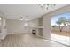 Bright living room featuring wood-look floors, fireplace and sliding glass doors to the patio at 1909 Falling Tree Ave, North Las Vegas, NV 89031