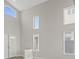 Large, naturally lit living area with high ceilings, multiple windows, and modern finishes at 1909 Falling Tree Ave, North Las Vegas, NV 89031