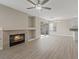 Spacious living room with fireplace, wood-look floors, and access to the outdoor space at 1909 Falling Tree Ave, North Las Vegas, NV 89031