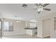 Bright living room featuring wood-look floors and open access to the kitchen area at 1909 Falling Tree Ave, North Las Vegas, NV 89031
