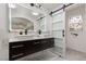 Stylish bathroom featuring double sinks, modern lighting, and a sliding door at 1911 Venalynne St, Las Vegas, NV 89156