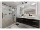 Modern bathroom with double sinks, a glass shower, and elegant marble tiling at 1911 Venalynne St, Las Vegas, NV 89156