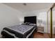 Inviting bedroom with a comfortable bed, side table and mirrored closet doors at 1911 Venalynne St, Las Vegas, NV 89156